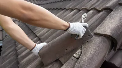 Roof repair in Sarasota showing storm-damaged shingles and flashing on a Southwest Florida home after hurricane season.