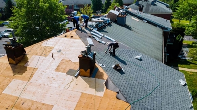 aerial view of people laying down roof shingles