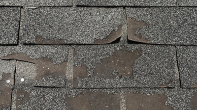 Asphalt shingles with missing granules