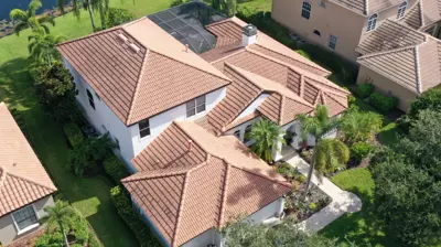 Aerial drone photo of a concrete tile roof on a Southwest Florida home, showing the barrel tile style and roof condition discussed in this tile roof lifespan guide.