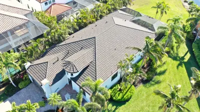Aerial drone photo of a complete concrete tile roof on a home in Lakewood Ranch, Florida, showing the overall tile roof structure and condition.