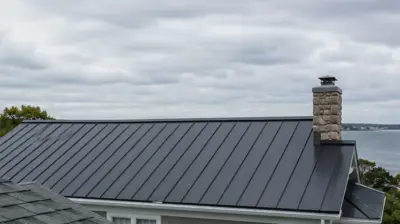Providence RI roof replacement comparison showing architectural shingles and standing seam metal roofing options.