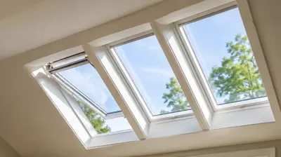 Modern Rhode Island home interior with energy-efficient venting skylights providing natural light, passive ventilation, and improved thermal performance in a vaulted living room ceiling.