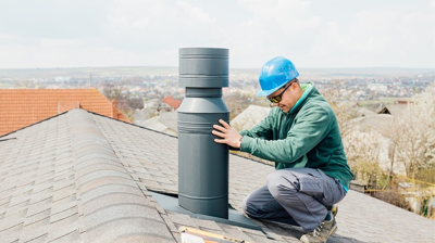 Roofing contractor performing chimney and roof integration services