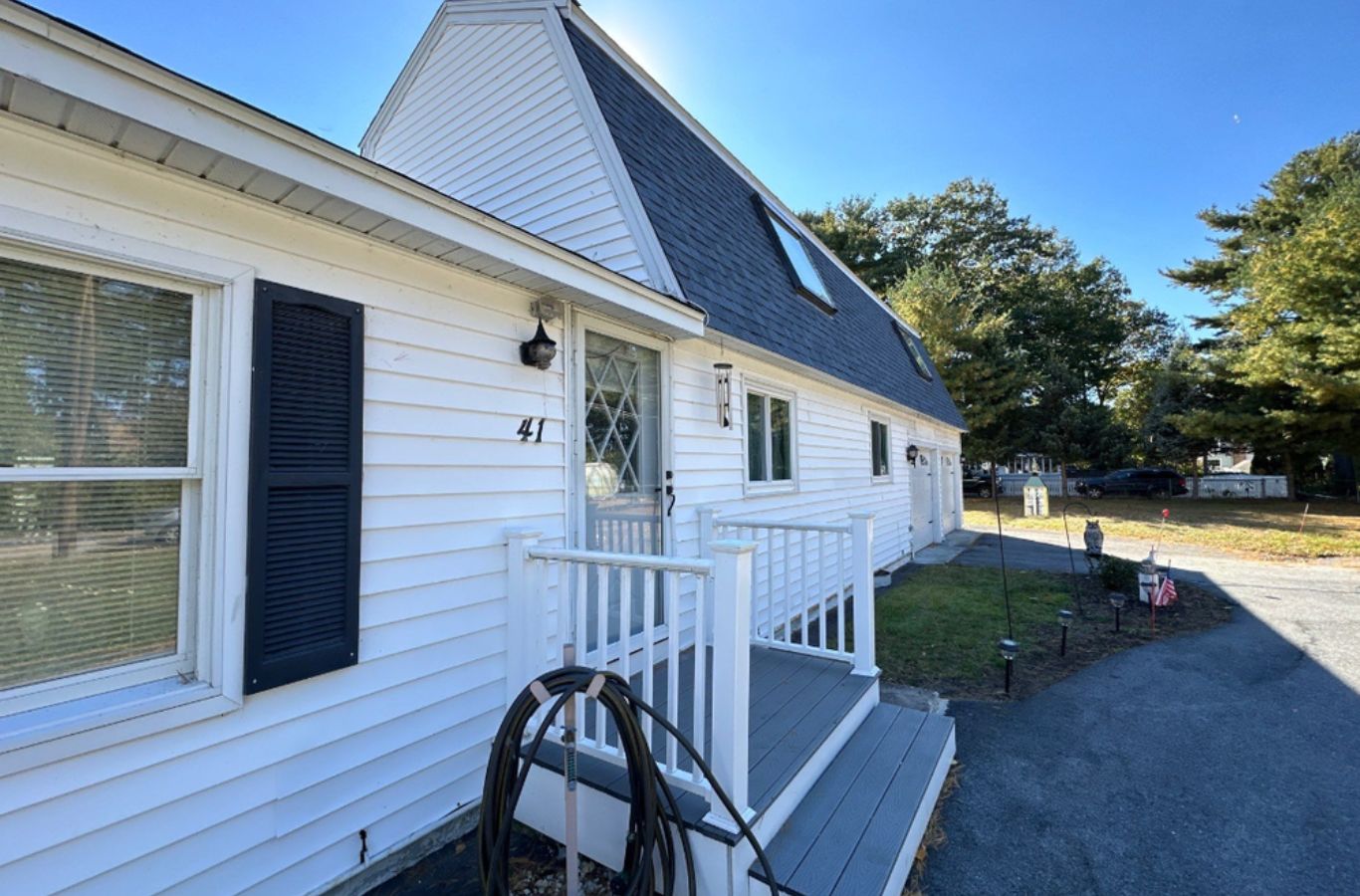 A Mighty Dog Roofing team cutting gutters on-site in Maynard, MA to install a seamless system customized for the home.