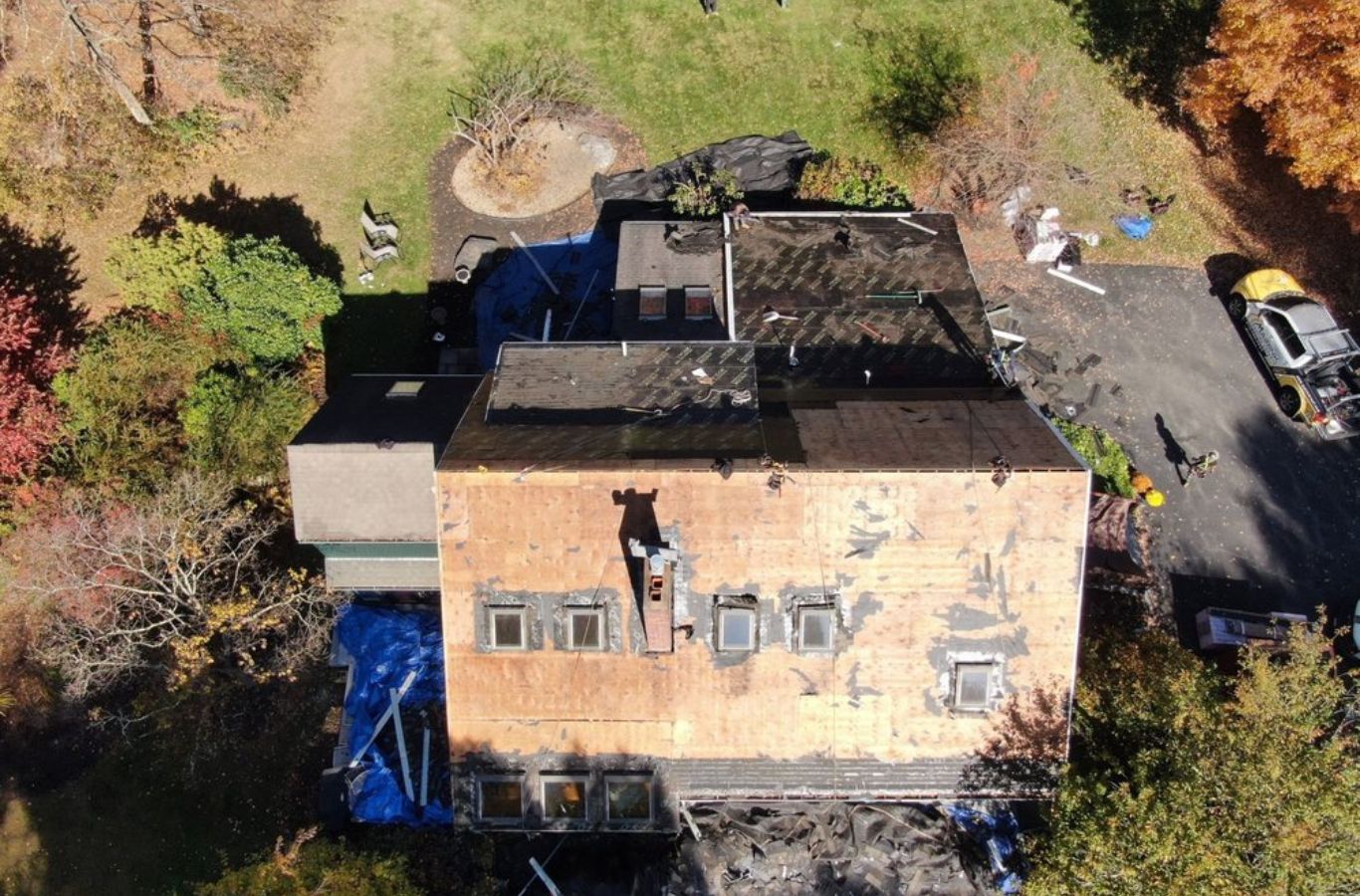 A Mighty Dog Roofing of Greater Middlesex County crew repairing roof features in Belmont, MA, showcasing meticulous workmanship.