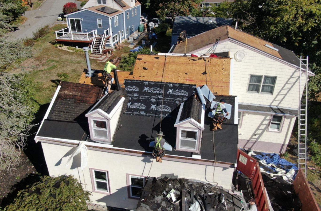 A Mighty Dog Roofing of Greater Middlesex County team member performing roof repair in Carlisle, MA, matching materials and ensuring lasting results.