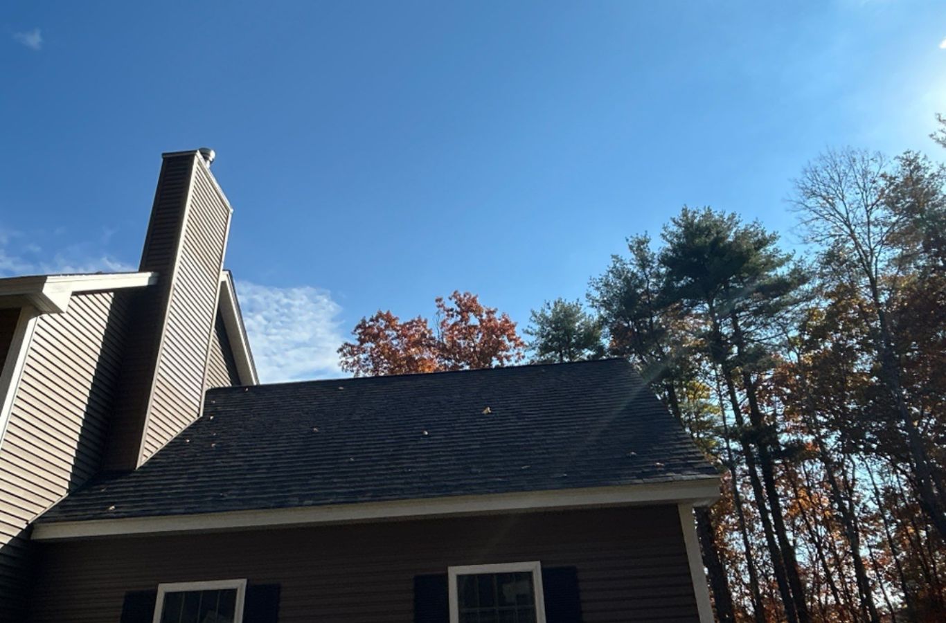 A Mighty Dog Roofing of Greater Middlesex County technician aligning siding panels on a Chelmsford, MA home to improve durability and enhance curb appeal.