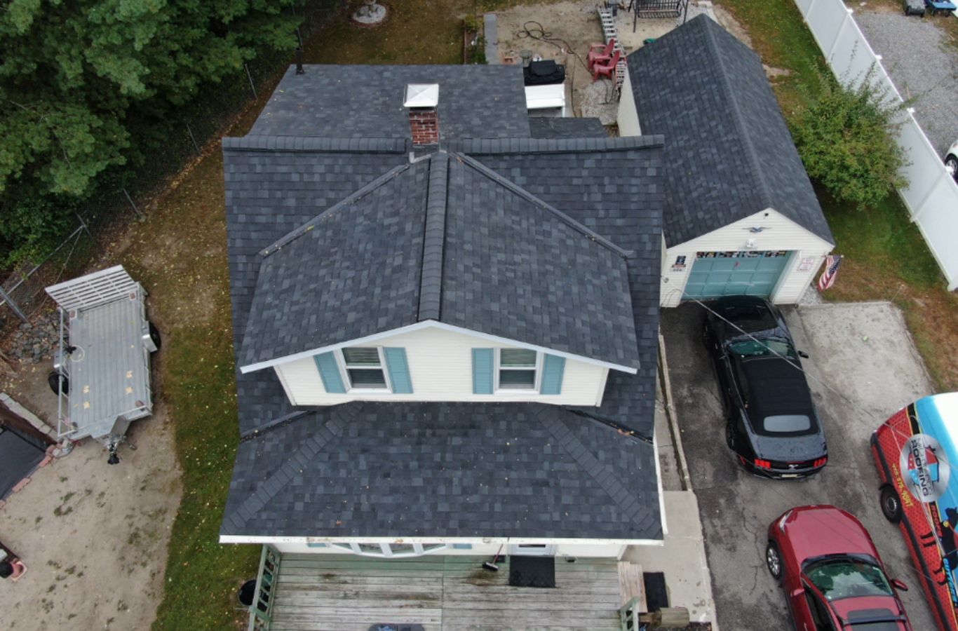 A technician from Mighty Dog Roofing installing energy-efficient siding in Lowell, MA, helping protect the home from harsh seasonal weather.