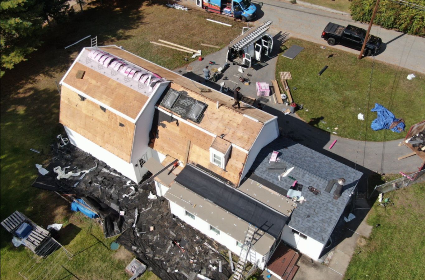 A Mighty Dog Roofing of Greater Middlesex County technician repairing a residential roof in Groton, MA, ensuring dependable and weather-resistant results.