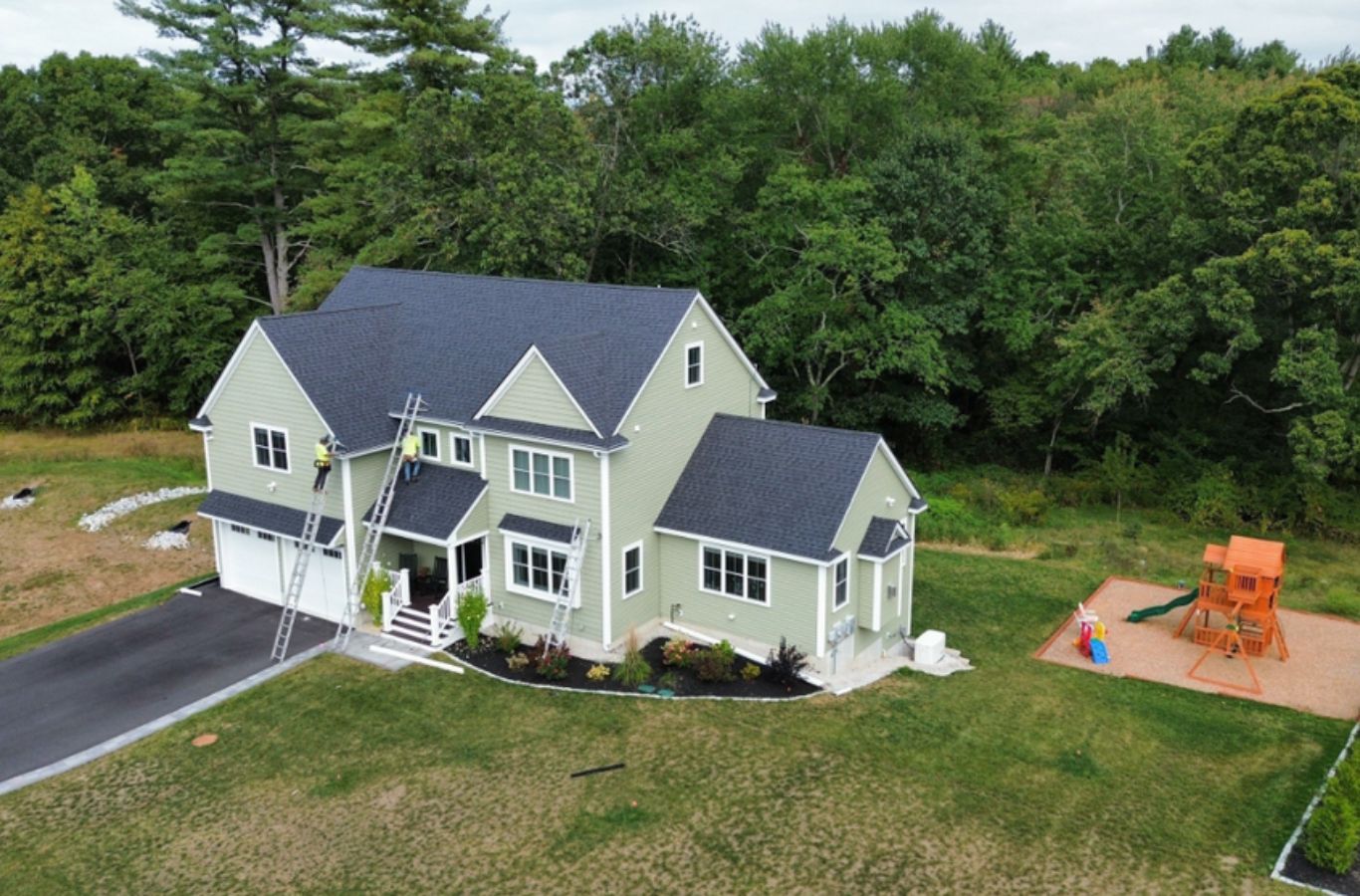 A Mighty Dog Roofing of Greater Middlesex County crew installing siding in Andover, MA with expert tools, precise techniques, and quality materials.