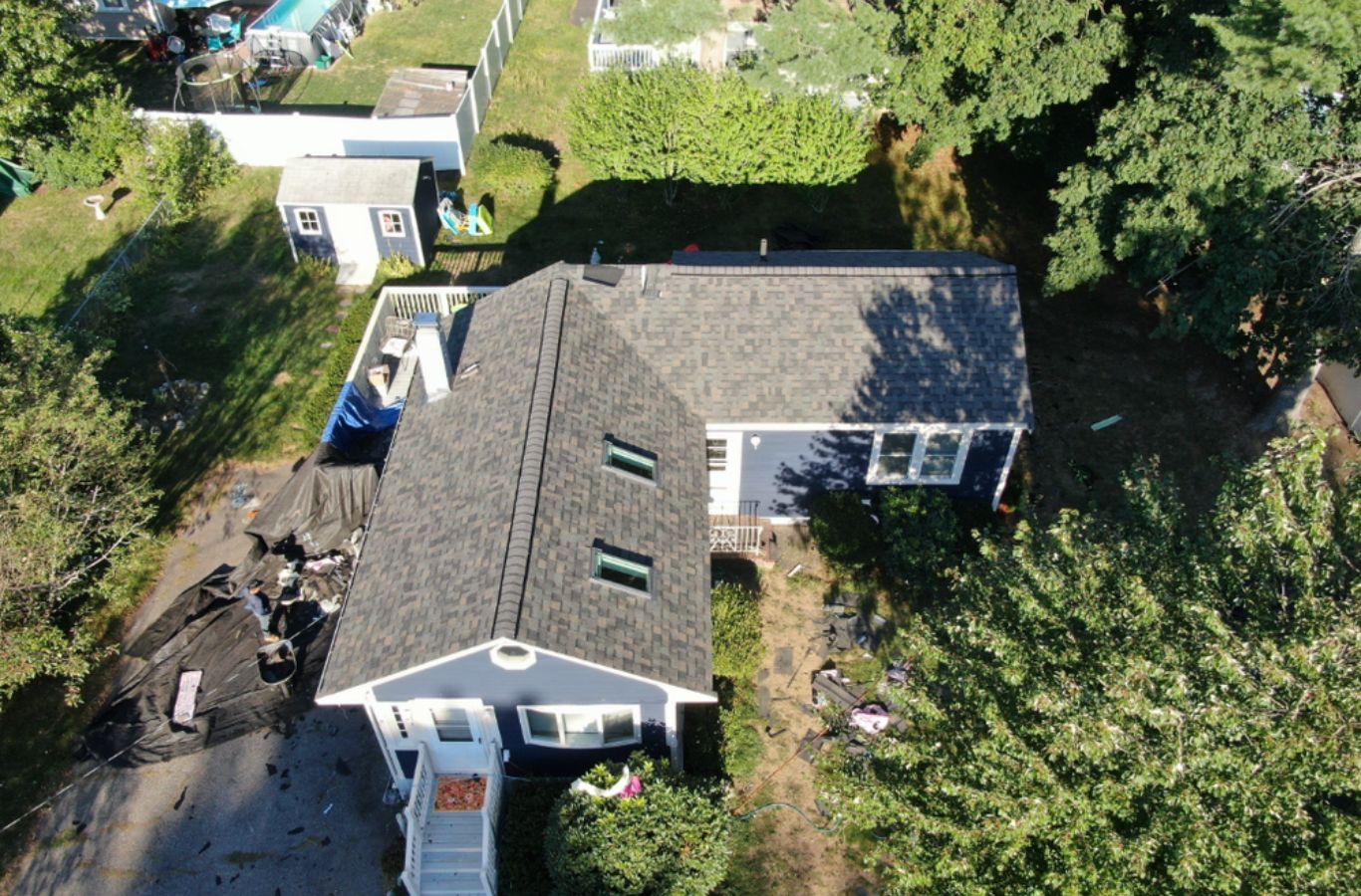 A Mighty Dog Roofing of Greater Middlesex County team member installing durable siding in Lexington, MA using advanced tools and expert technique.