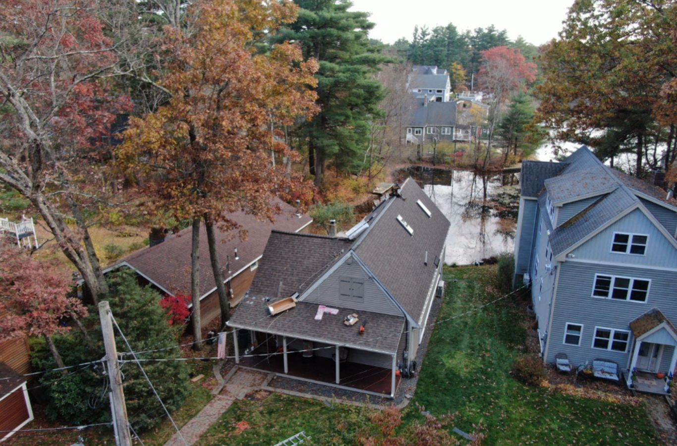 A Mighty Dog Roofing of Greater Middlesex County expert installing siding in Littleton, MA using high-quality panels and tools for long-term protection.
