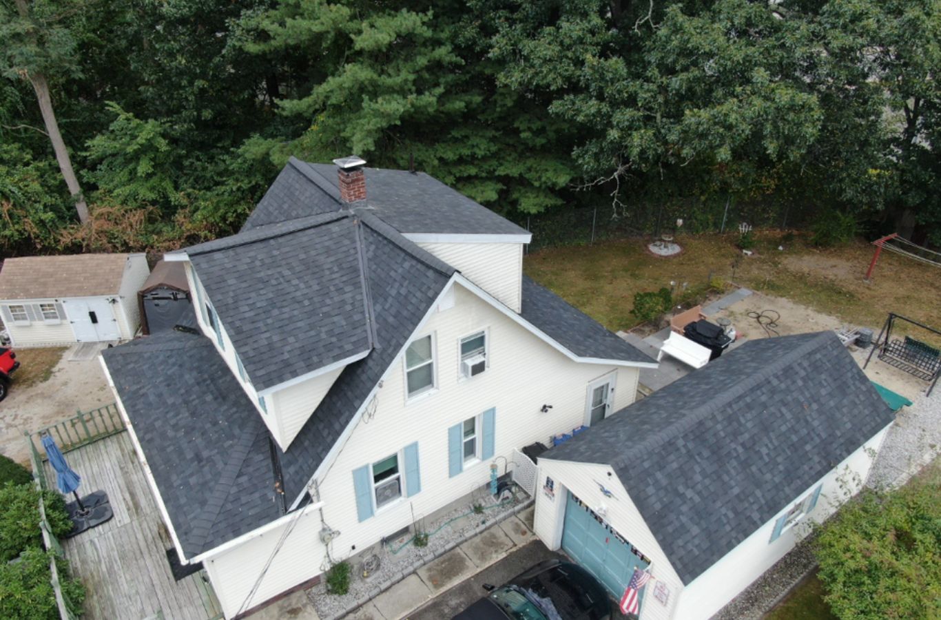 A Mighty Dog Roofing of Greater Middlesex County installer working on siding in Methuen, MA using advanced tools and weather-resistant panels.