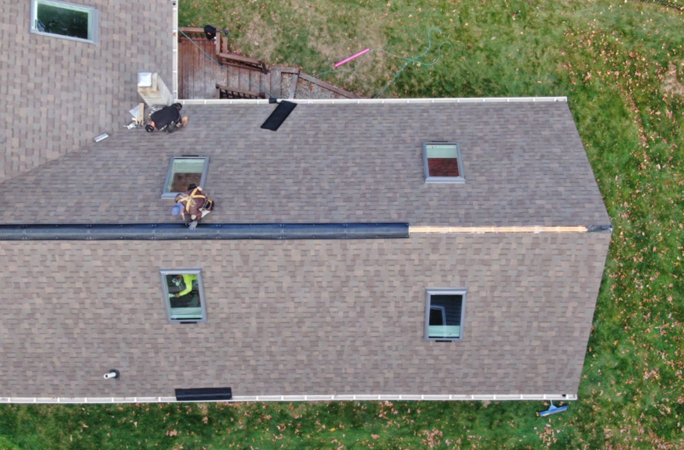 A Mighty Dog Roofing technician securing siding panels in Woburn, MA with precision tools and expert craftsmanship.
