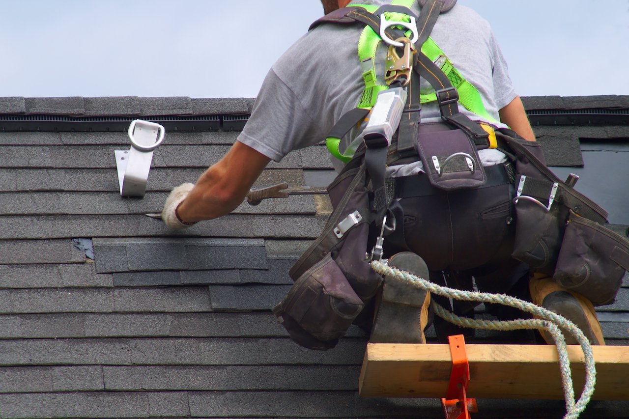 Roof repair crew working on a residential roof in Sarasota, FL