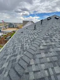 Completed roof replacement with new architectural shingles and clean gutters on a Thornton, CO home