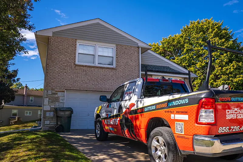 Mighty Dog Roofing truck parked in front of the house that needs a roof inspection