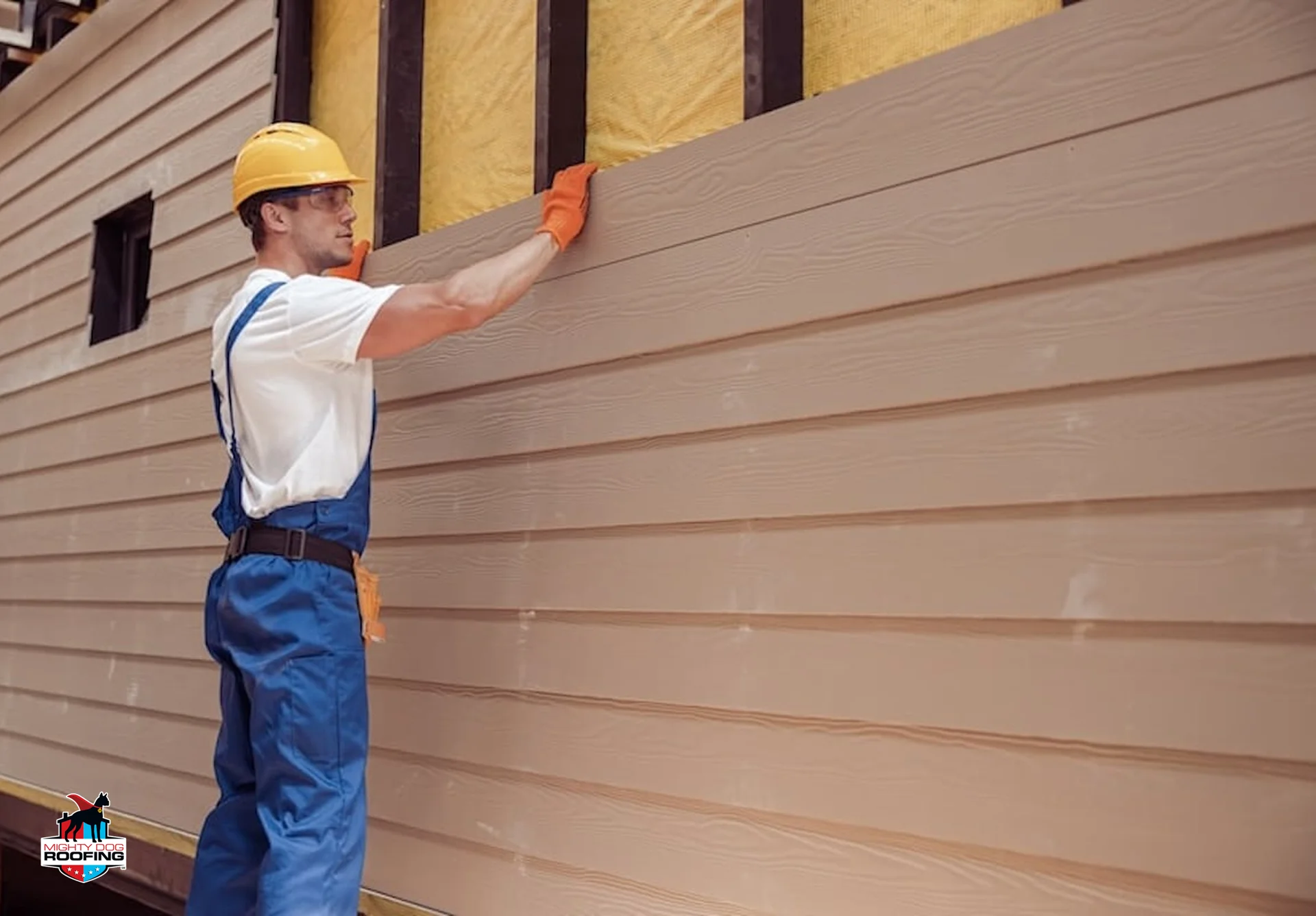 Siding contractor installing exterior panels