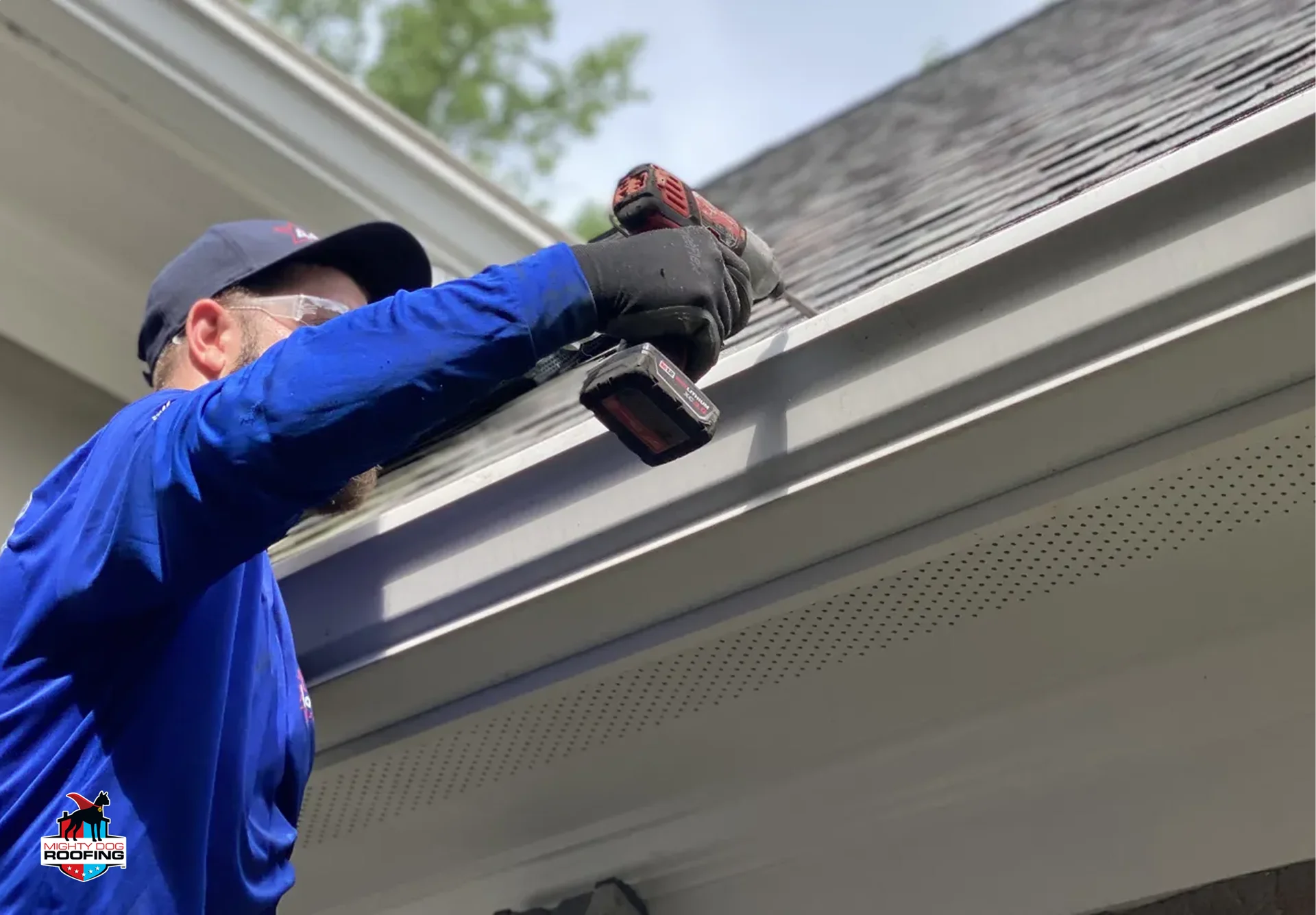 Gutter contractor installing new gutters